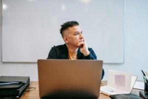 pexels-photo-6325938-6325938 Focused businessman in home office, pondering work thoughts. Perfect for remote work and telecommuting concepts.
