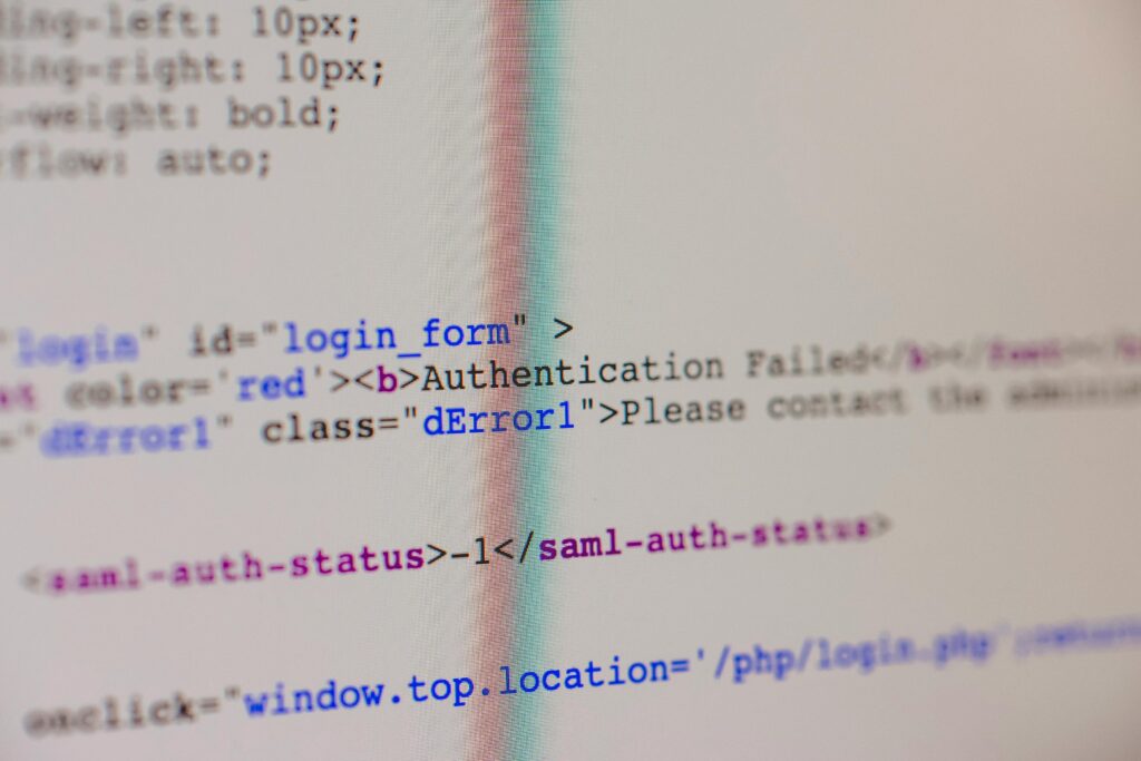 Close-up of HTML and PHP code on screen showing error message and login form data.