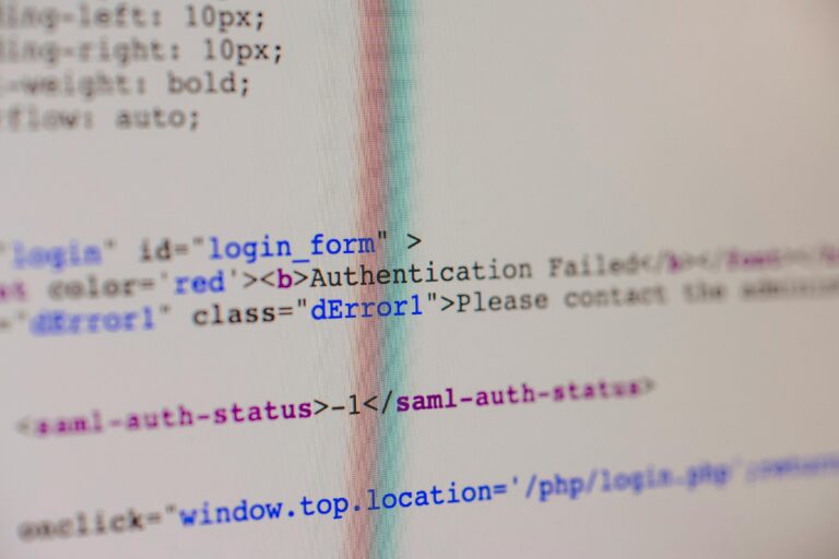 Close-up of HTML and PHP code on screen showing error message and login form data.