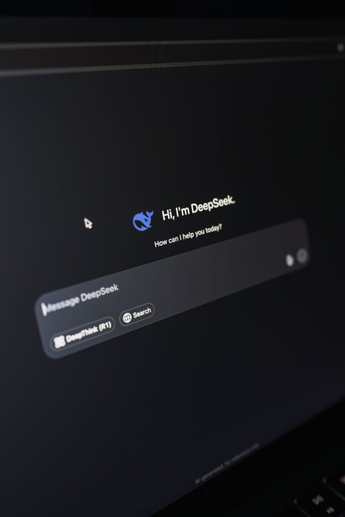pexels-photo-30530412-30530412 Close-up of a laptop displaying an AI interface with a chatbot prompt in dark mode.